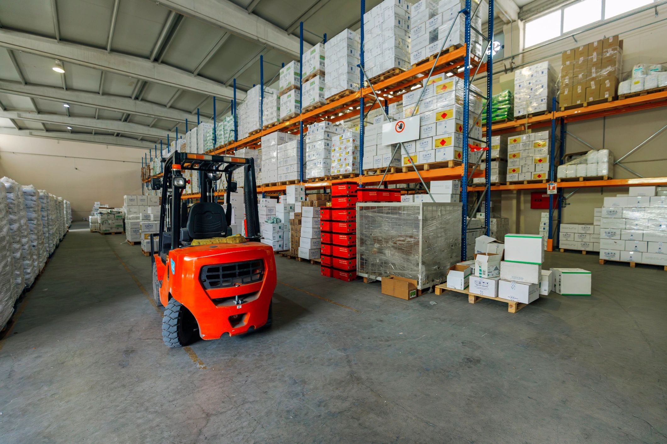 Warehouse aisle with organized inventory and forklift